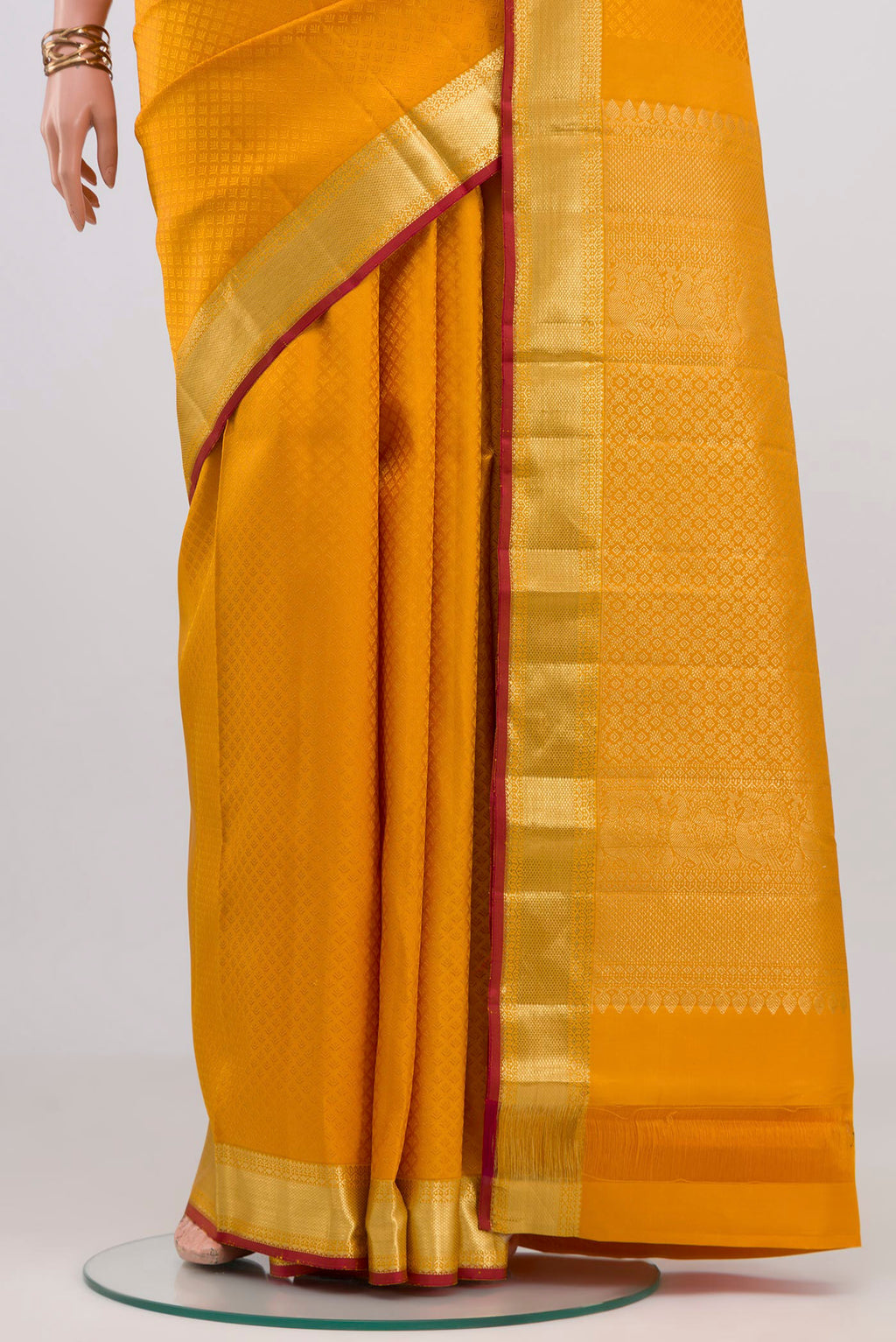 Pleats and pallu of Yellow Kanjivaram Silk Saree with Jacquard design on the body and Zari Border. 