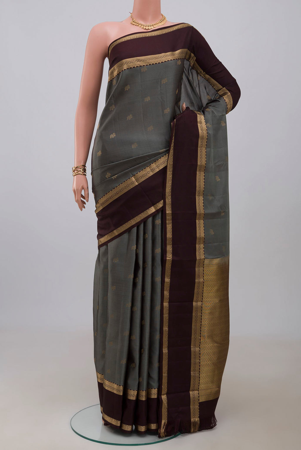 Grey Kanchipuram Silk Saree with Zari Butta on the body and Zari Border.  displayed on a mannequin