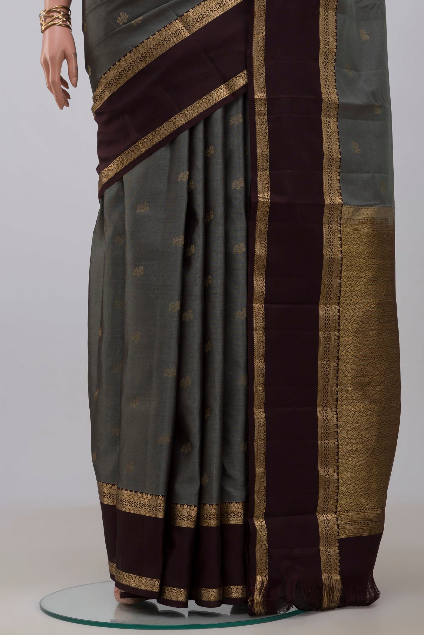 Pleats and pallu of Grey Kanchipuram Silk Saree with Zari Butta on the body and Zari Border. 