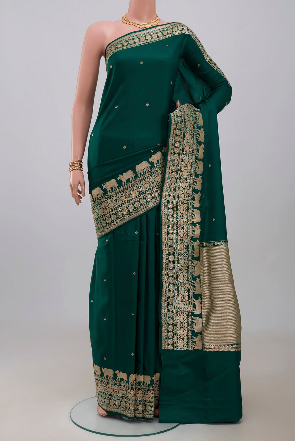 Green Banarasi Saree with Zari Butta on the body and Fancy Border.  displayed on a mannequin