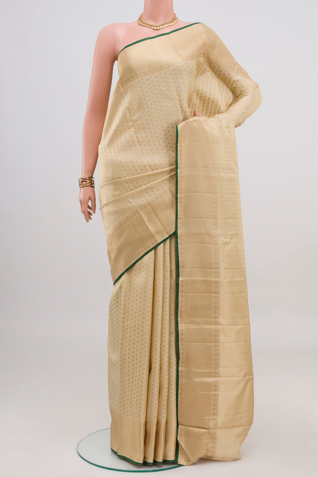 Cream Kanchipuram Silk Saree with Jacquard design on the body and Thread Border.  displayed on a mannequin