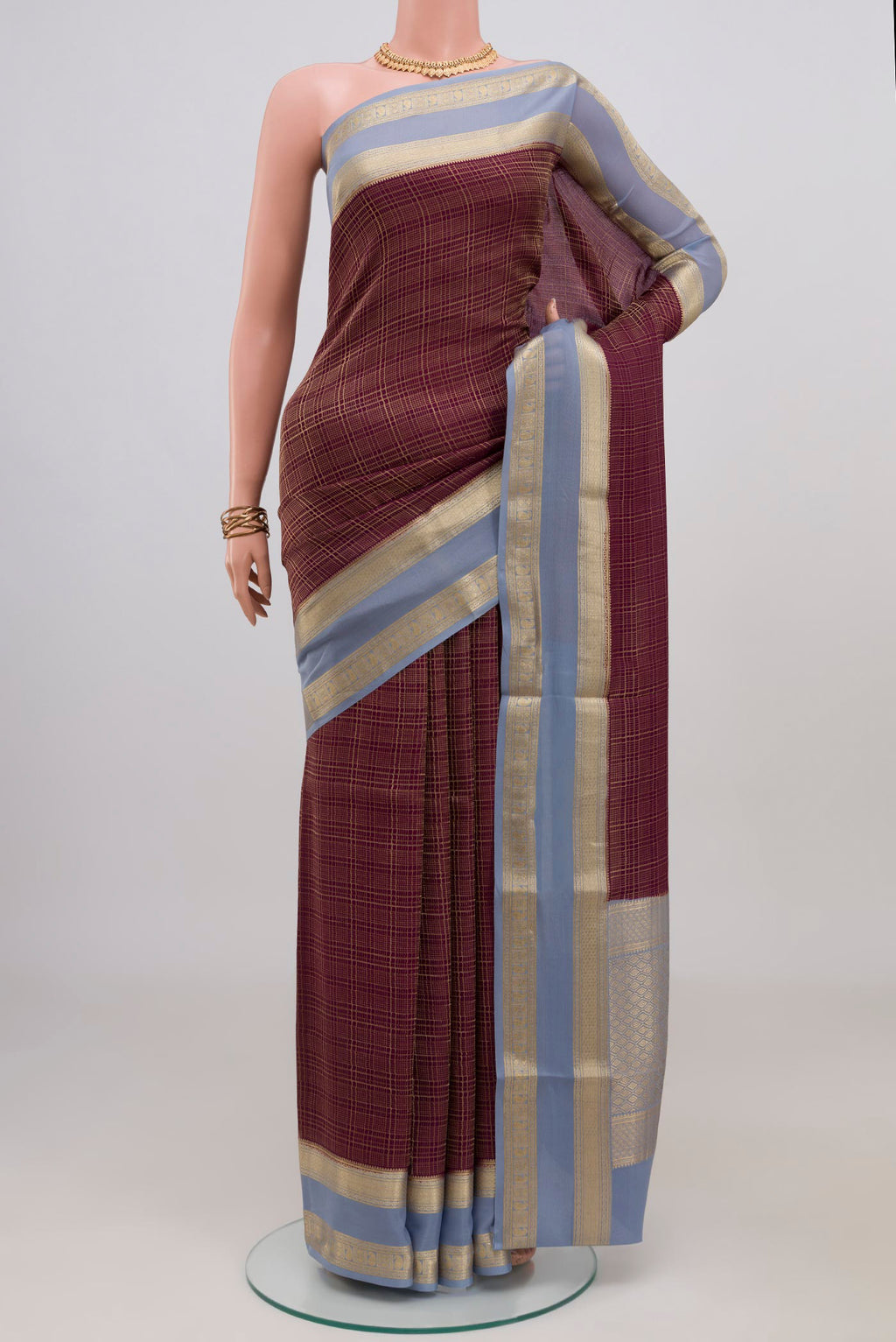 Burgundy Mysore Crepe Saree with Checked design on the body and Zari Border.  displayed on a mannequin