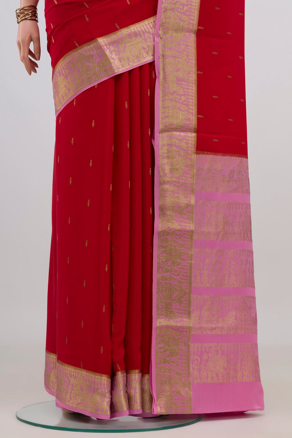 Pleats and pallu of Red Mysore Crepe Saree with Zari Butta on the body and Zari Border. 