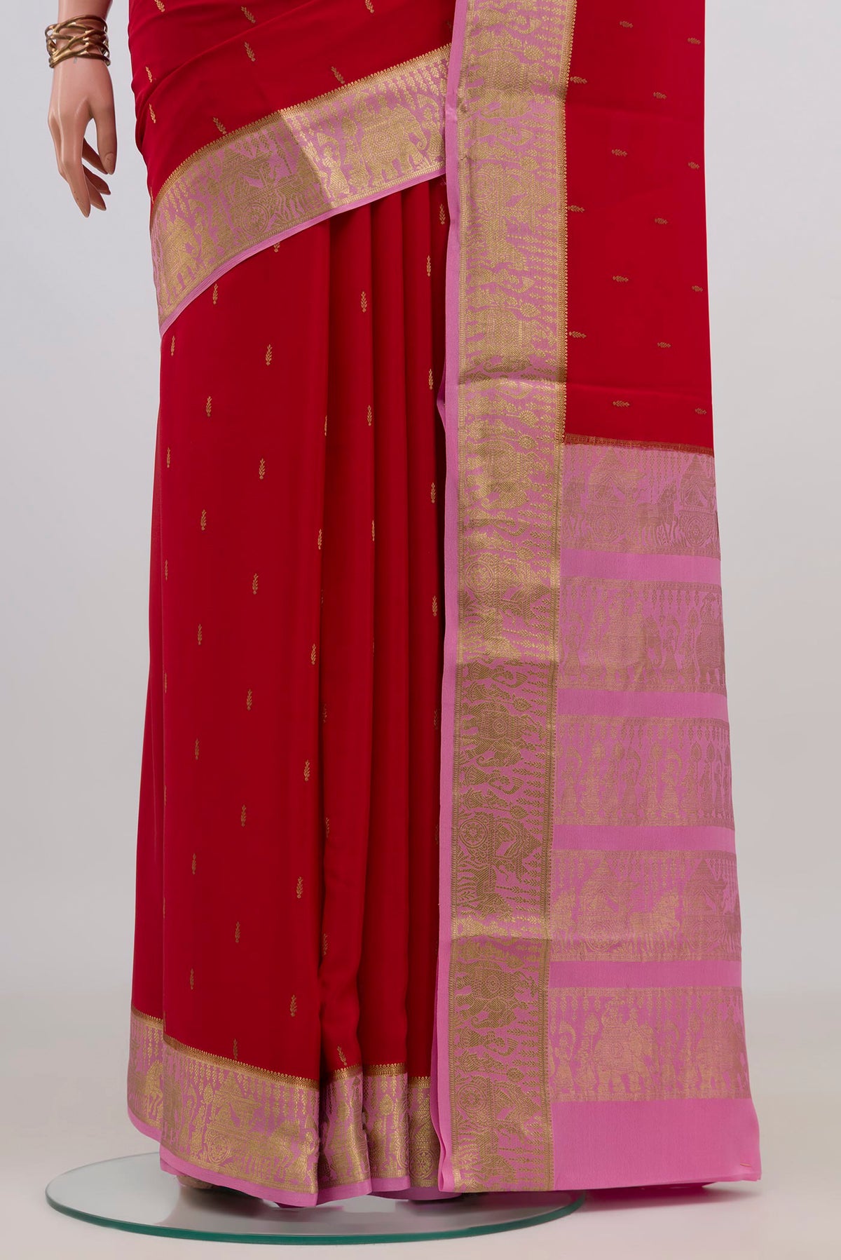 Pleats and pallu of Red Mysore Crepe Saree with Zari Butta on the body and Zari Border. 