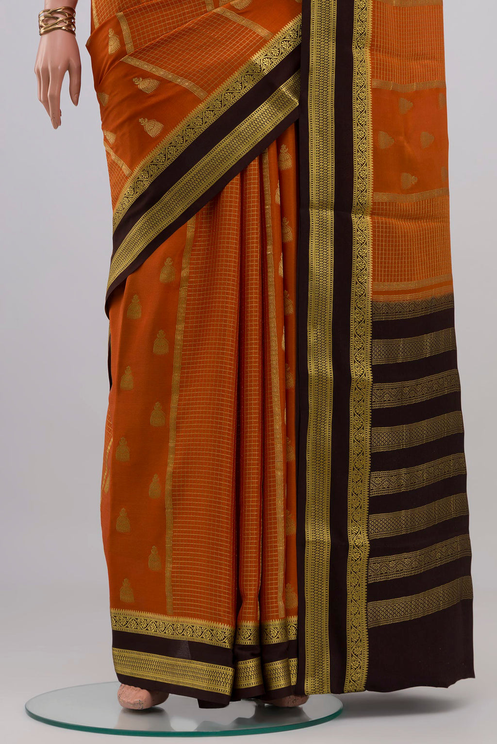 Pleats and pallu of Orange Mysore Crepe Saree with Zari Butta on the body and Zari Border. 