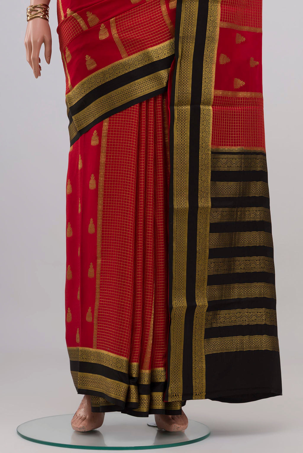 Pleats and pallu of Red Mysore Crepe Saree with Stripes on the body and Zari Border. 