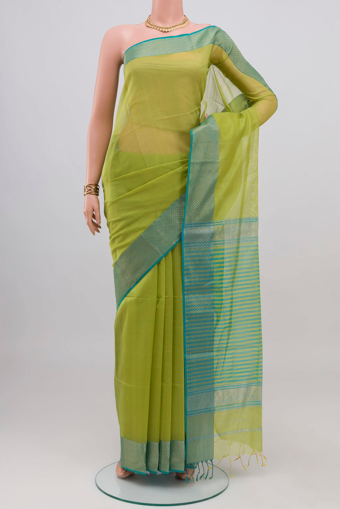 Light Green Maheshwari Silk Cotton Saree with Plain Body and Zari Border.  displayed on a mannequin