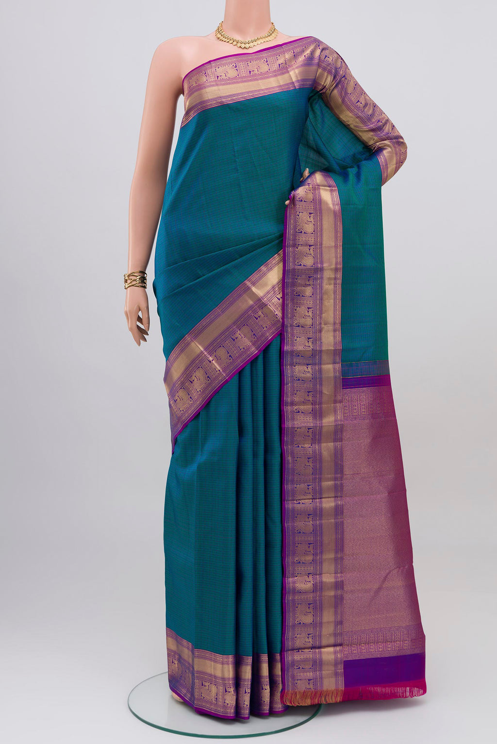 Peacock Blue Kanchipuram Saree with Checked design on the body and Zari Border.  displayed on a mannequin