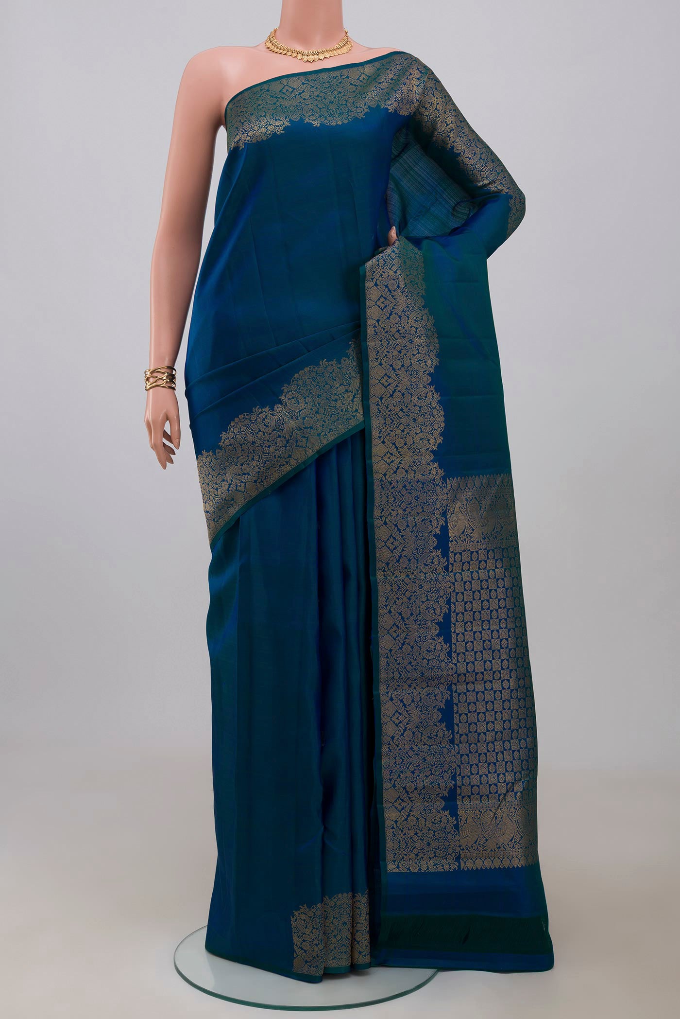 Blue Kanchipuram Saree with Plain Body and Fancy Border.  displayed on a mannequin