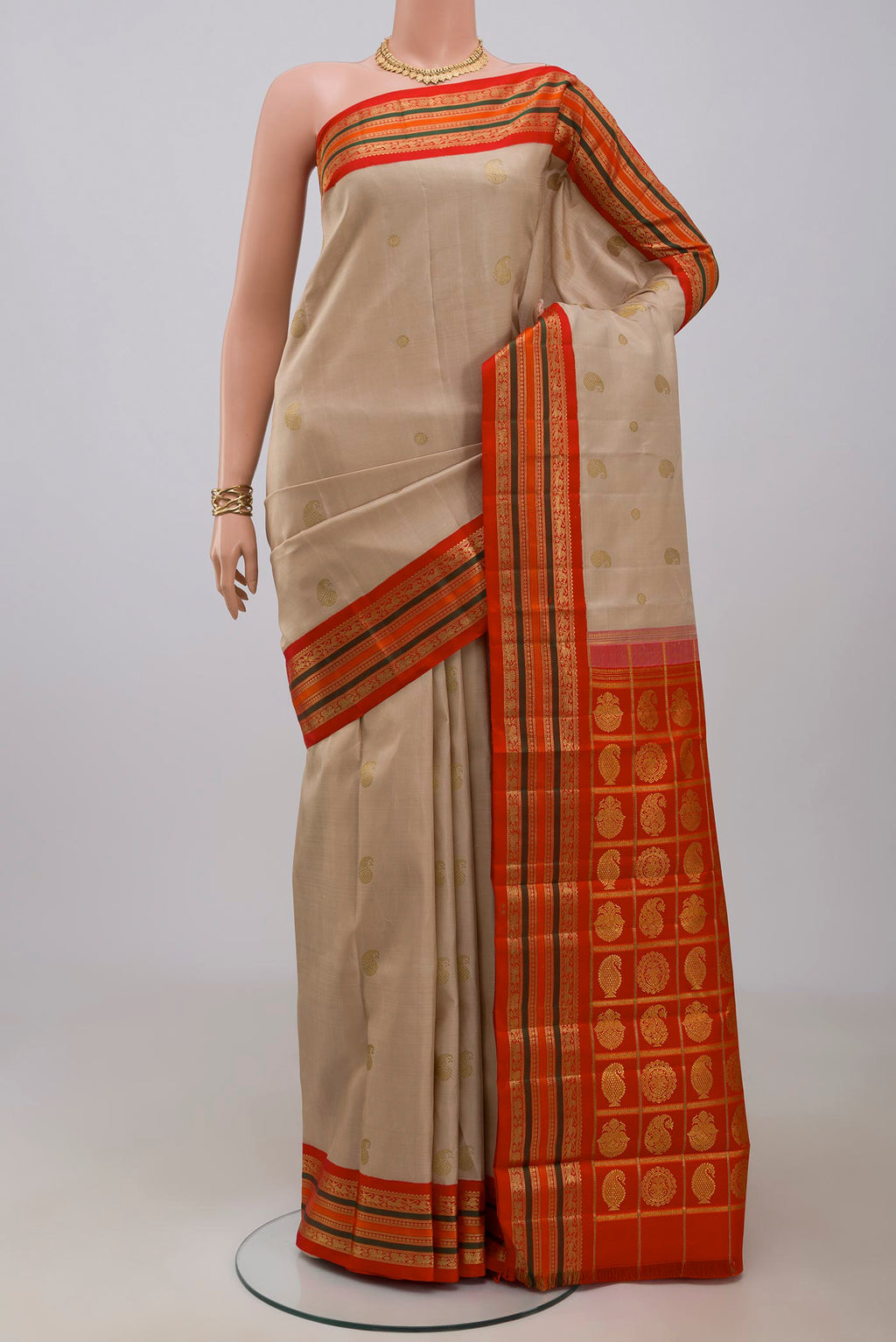 Pure Silk Pure Zari Beige Kanchipuram Saree with Zari Butta on the body and Zari Border.  displayed on a mannequin