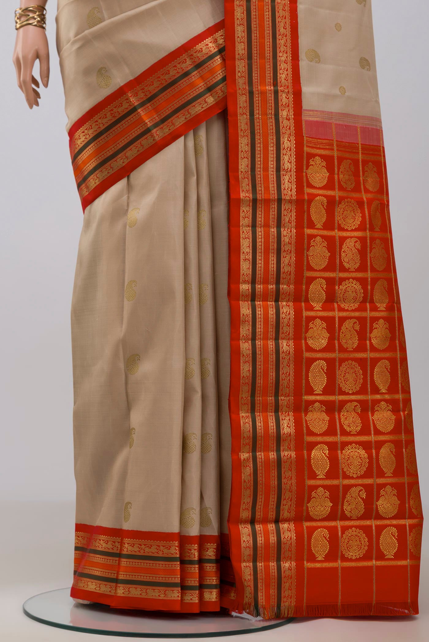 Pleats and pallu of Pure Silk Pure Zari Beige Kanchipuram Saree with Zari Butta on the body and Zari Border. 
