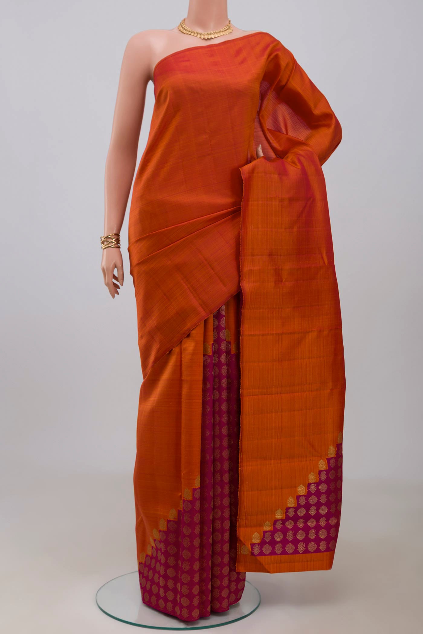 Pure Silk Pure Zari Rust Kanchipuram Saree with Plain Body and Without Border.  displayed on a mannequin
