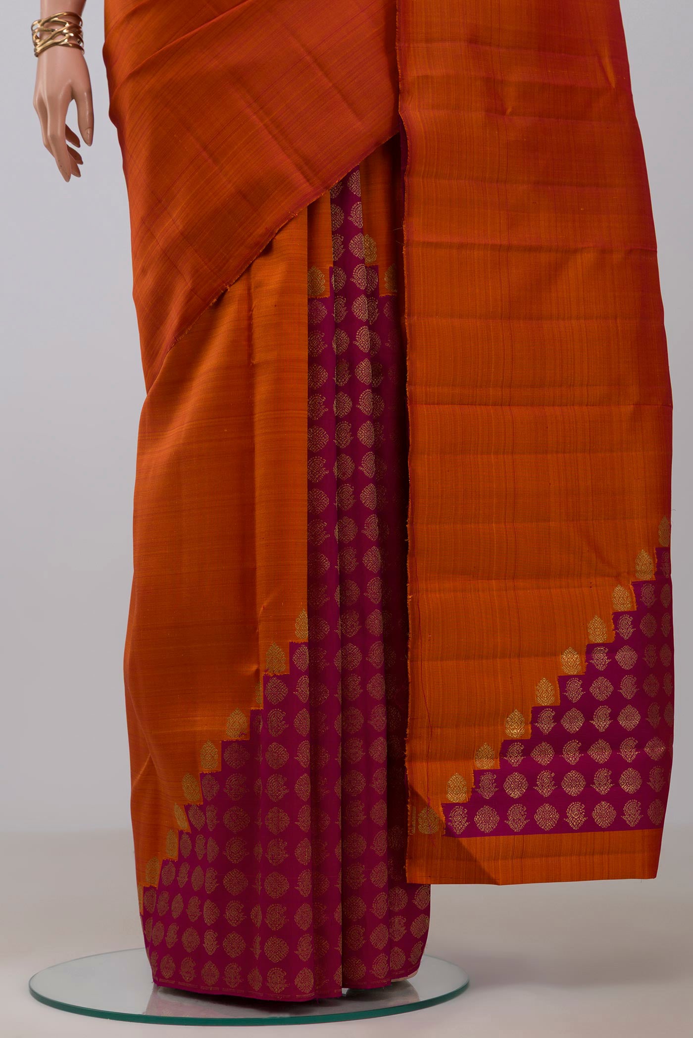 Pleats and pallu of Pure Silk Pure Zari Rust Kanchipuram Saree with Plain Body and Without Border. 