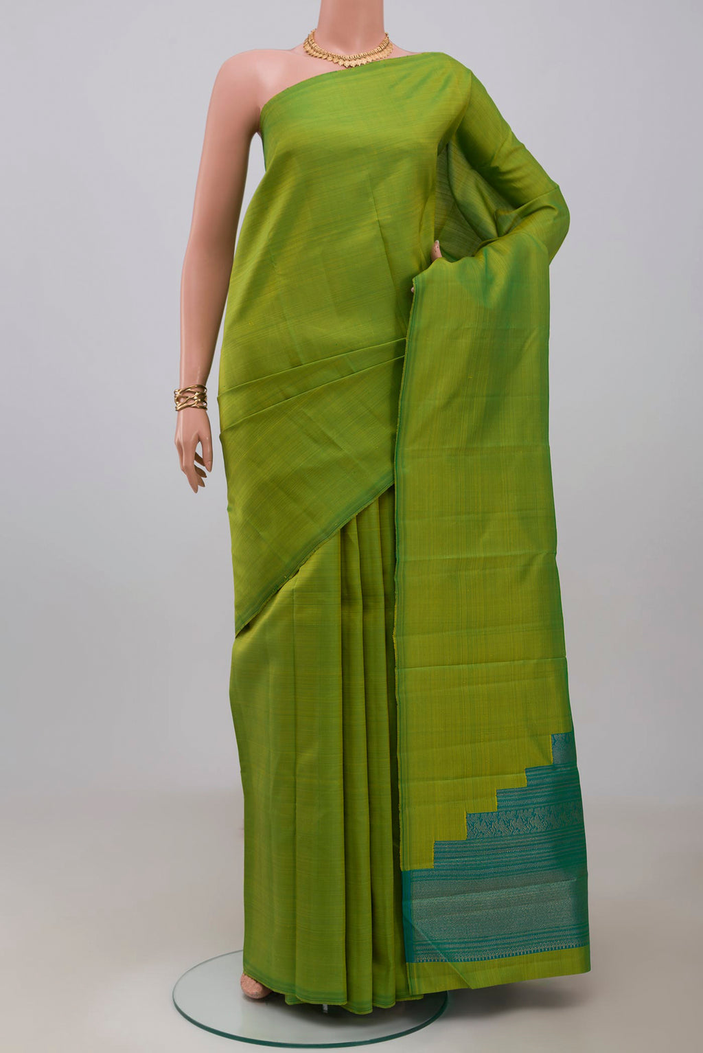 Pure Silk Pure Zari Green Kanchipuram Saree with Plain Body and Without Border.  displayed on a mannequin