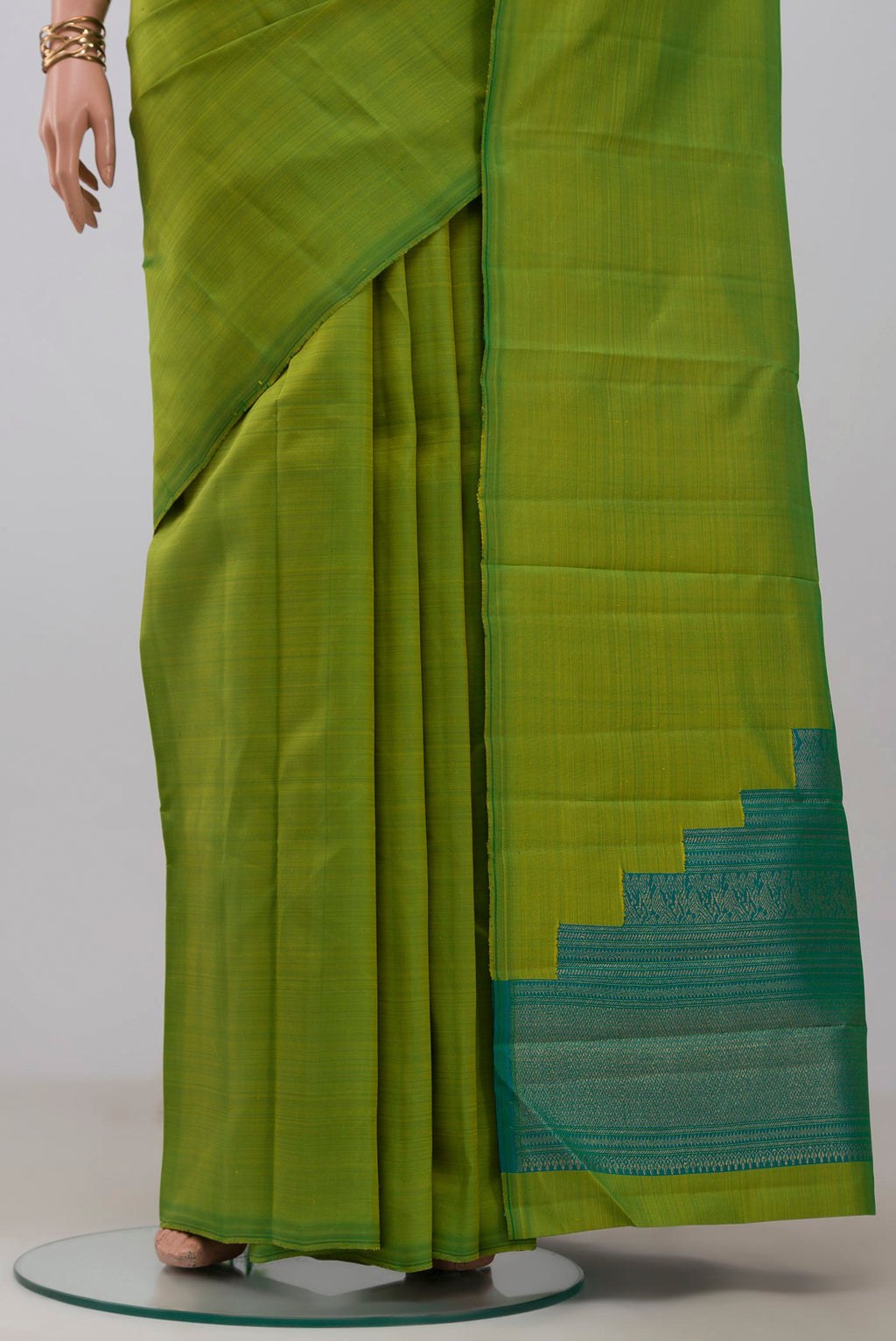 Pleats and pallu of Pure Silk Pure Zari Green Kanchipuram Saree with Plain Body and Without Border. 