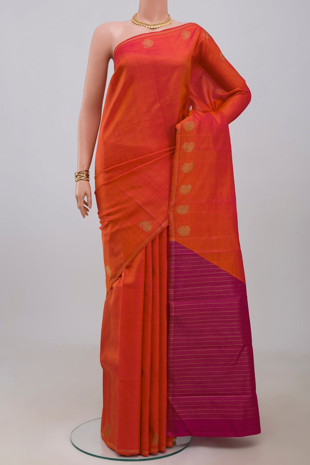 Pure Silk Pure Zari Orange Kanjivaram Saree with Fancy on the body and Thin Zari Line.  displayed on a mannequin