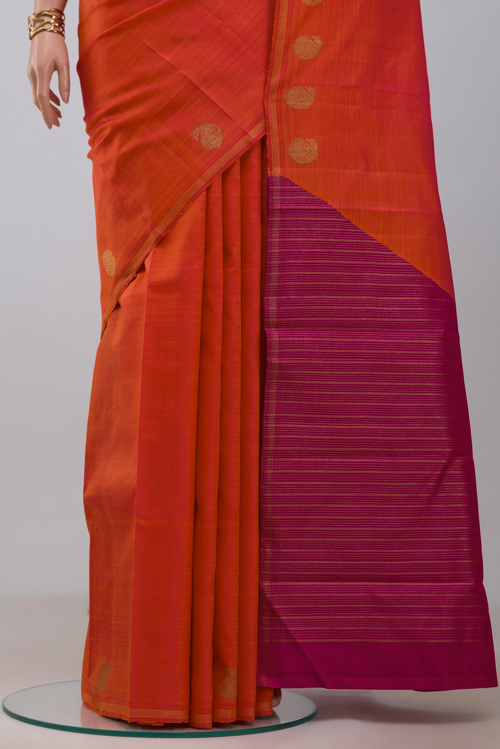 Pleats and pallu of Pure Silk Pure Zari Orange Kanjivaram Saree with Fancy on the body and Thin Zari Line. 