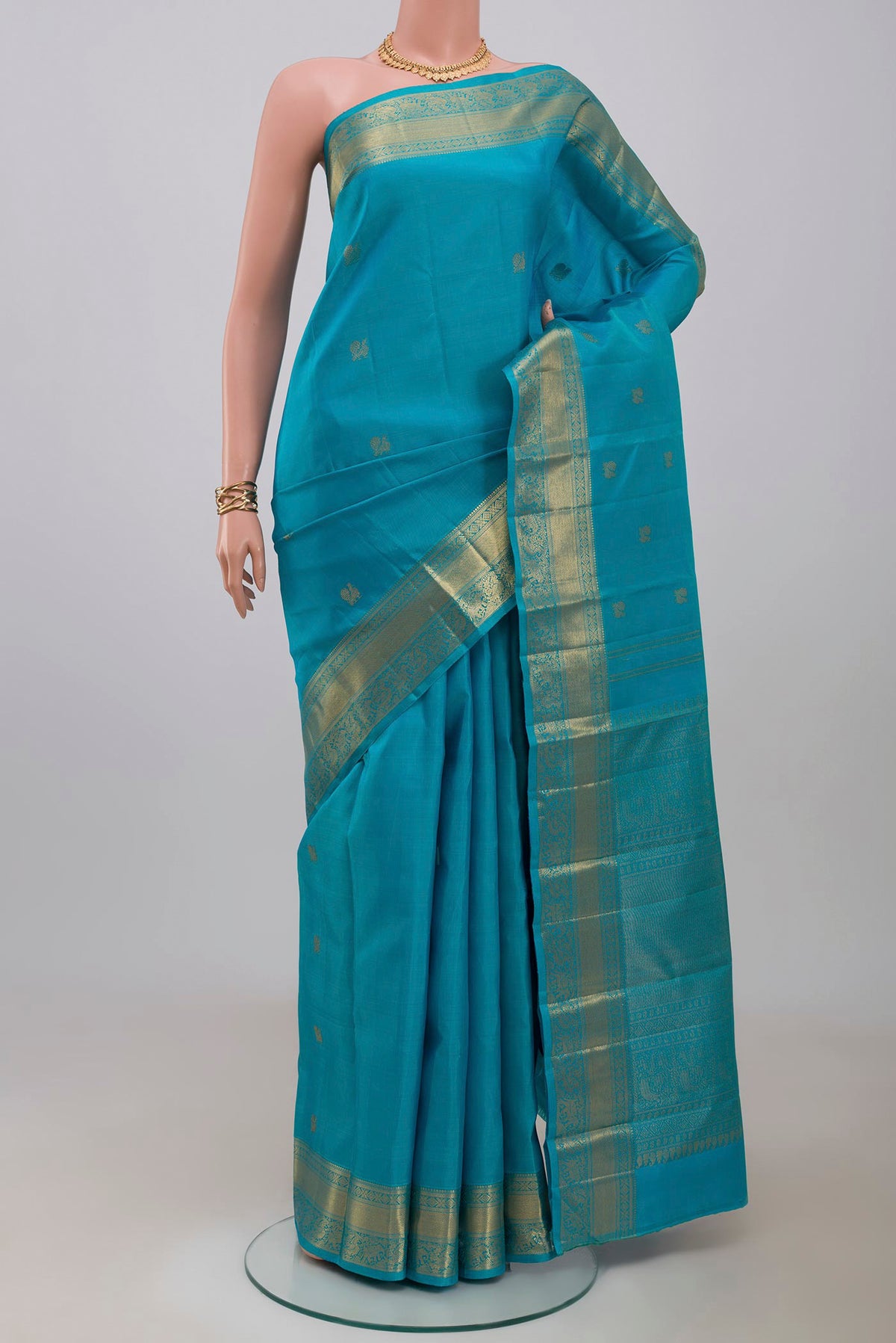 Pure Silk Pure Zari Blue Kanjivaram Saree with Zari Butta on the body and Zari Border.  displayed on a mannequin