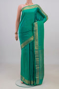 Pure Silk Sea Green Kanjivaram Saree with Zari Butta on the body and Zari Border.  displayed on a mannequin
