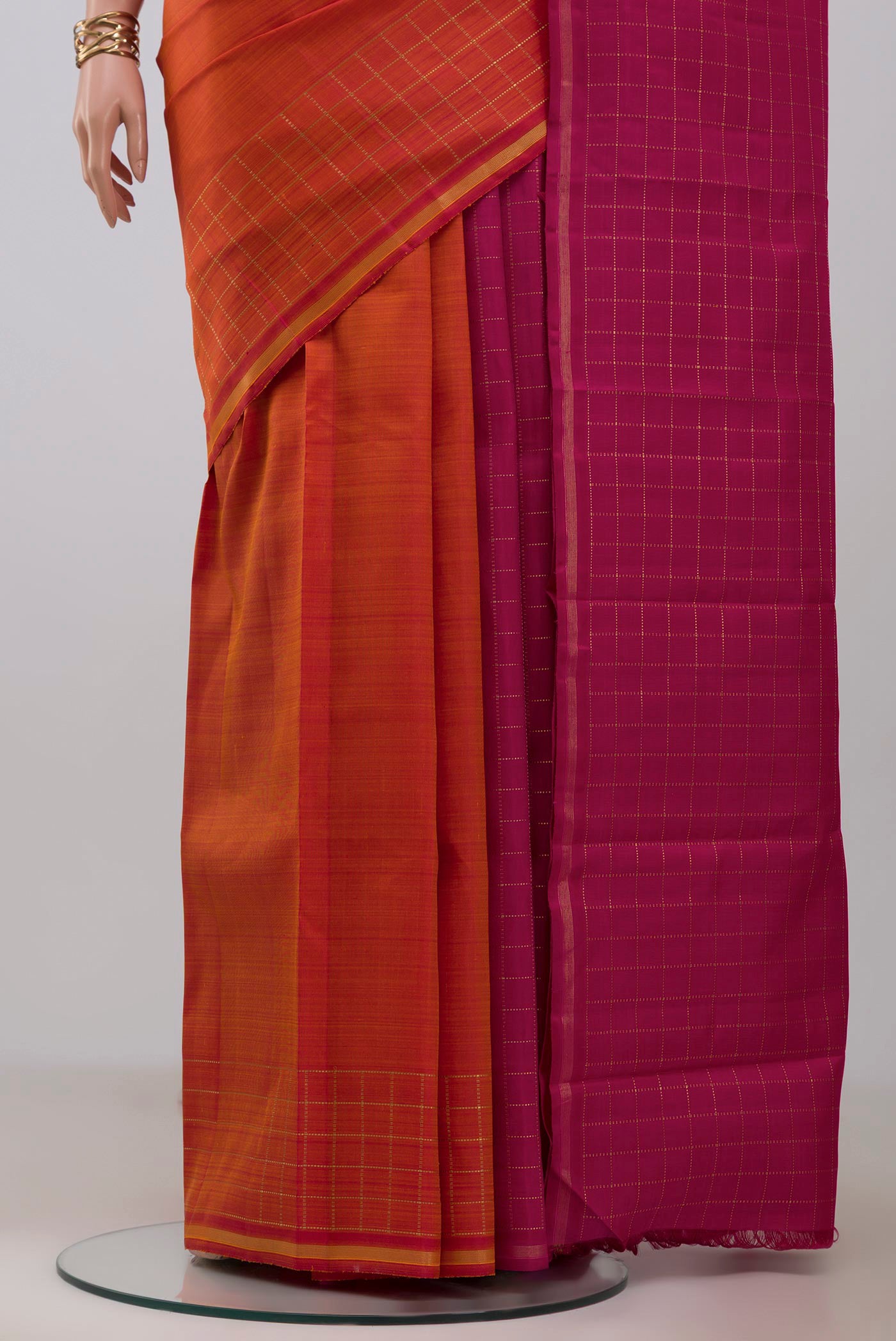 Pleats and pallu of Pure Silk Pure Zari Brick Orange Kanchipuram Saree with Plain Body and Checks Border. 