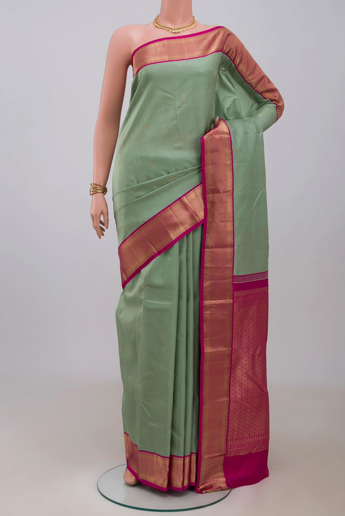 Sea Green Kanchipuram Saree with Zari Butta on the body and Zari Border.  displayed on a mannequin