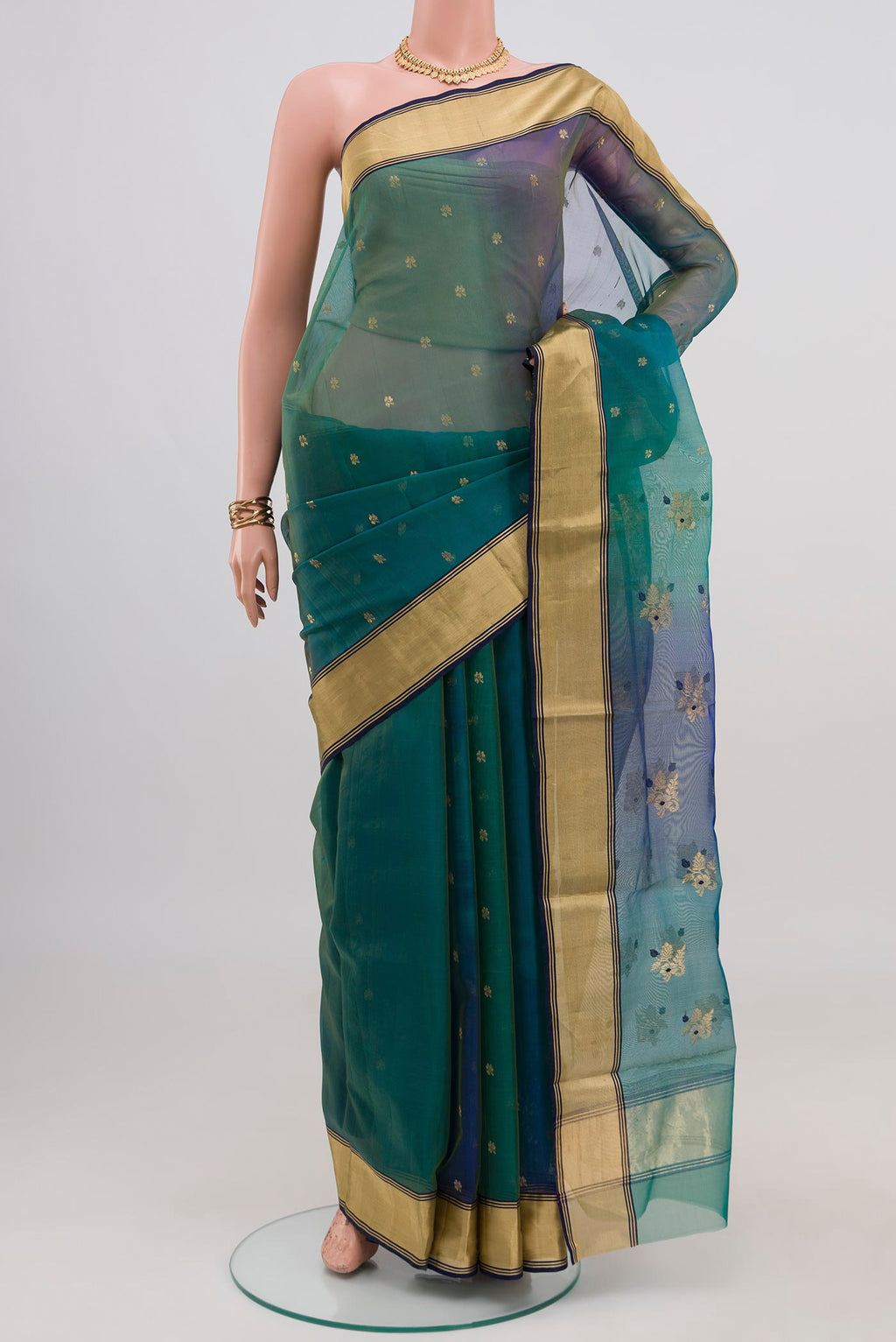 Green Dual Tone Chanderi Silk Cotton Saree with Zari Butta on the body and Zari Border.  displayed on a mannequin