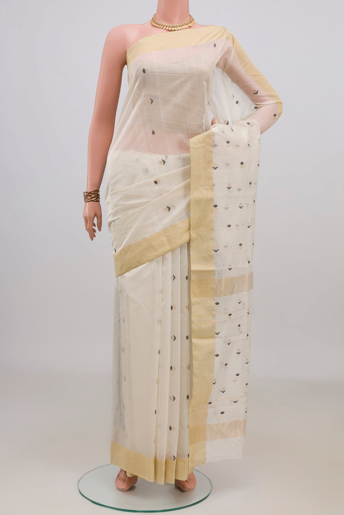 Off White Chanderi Cotton Saree with Zari Butta on the body and Zari Border.  displayed on a mannequin