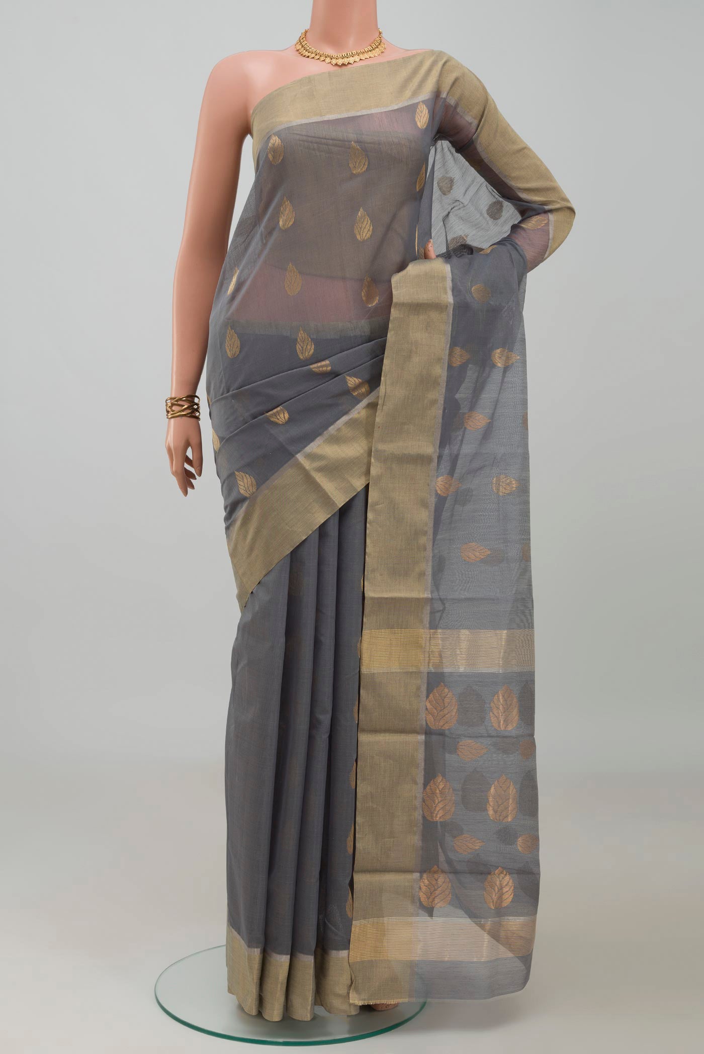 Grey Chanderi Silk Cotton Saree with Zari Butta on the body and Zari Border.  displayed on a mannequin