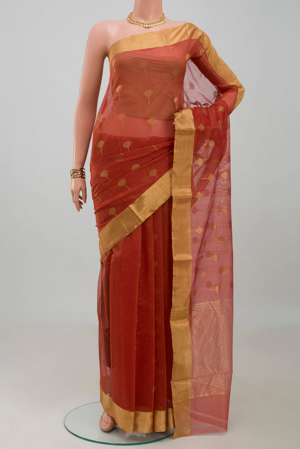 Rust Chanderi Silk Cotton Saree with Zari Butta on the body and Zari Border.  displayed on a mannequin
