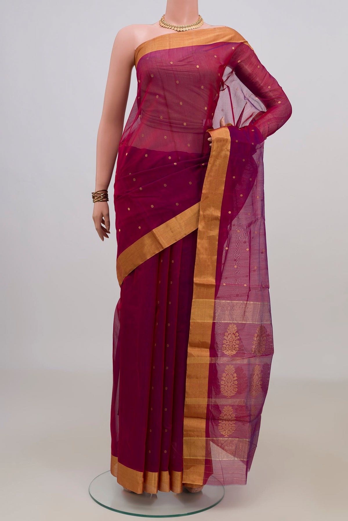 Magenta Chanderi Cotton Saree with Zari Butta on the body and Zari Border.  displayed on a mannequin