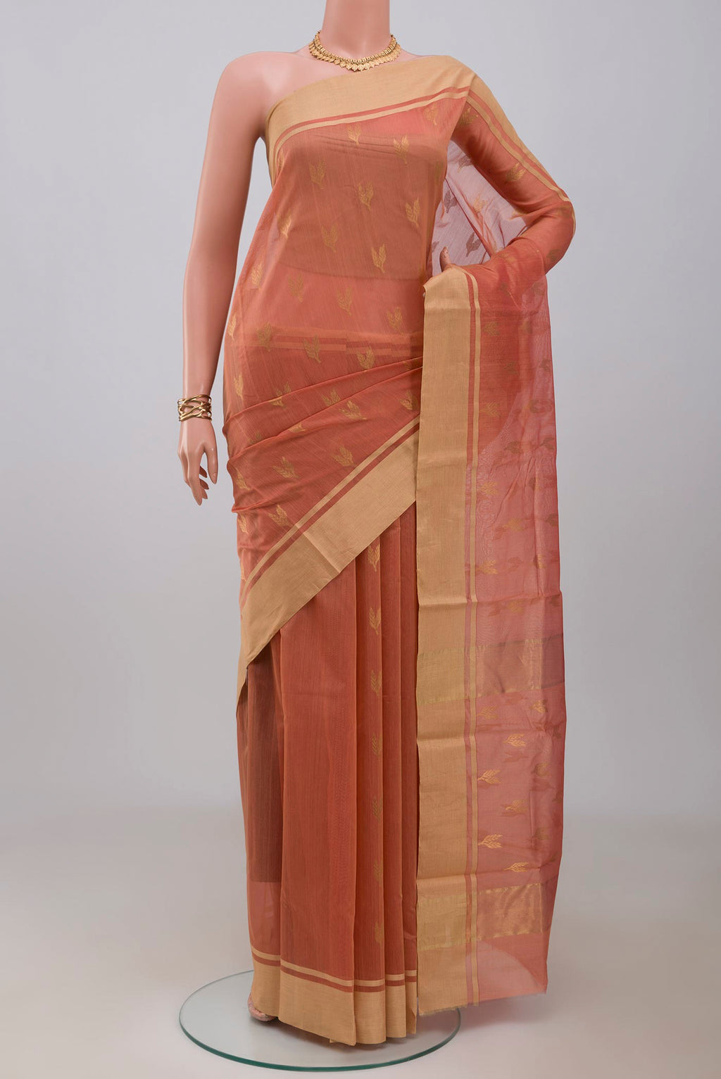 Peach Chanderi Silk Cotton Saree with Zari Butta on the body and Zari Border.  displayed on a mannequin