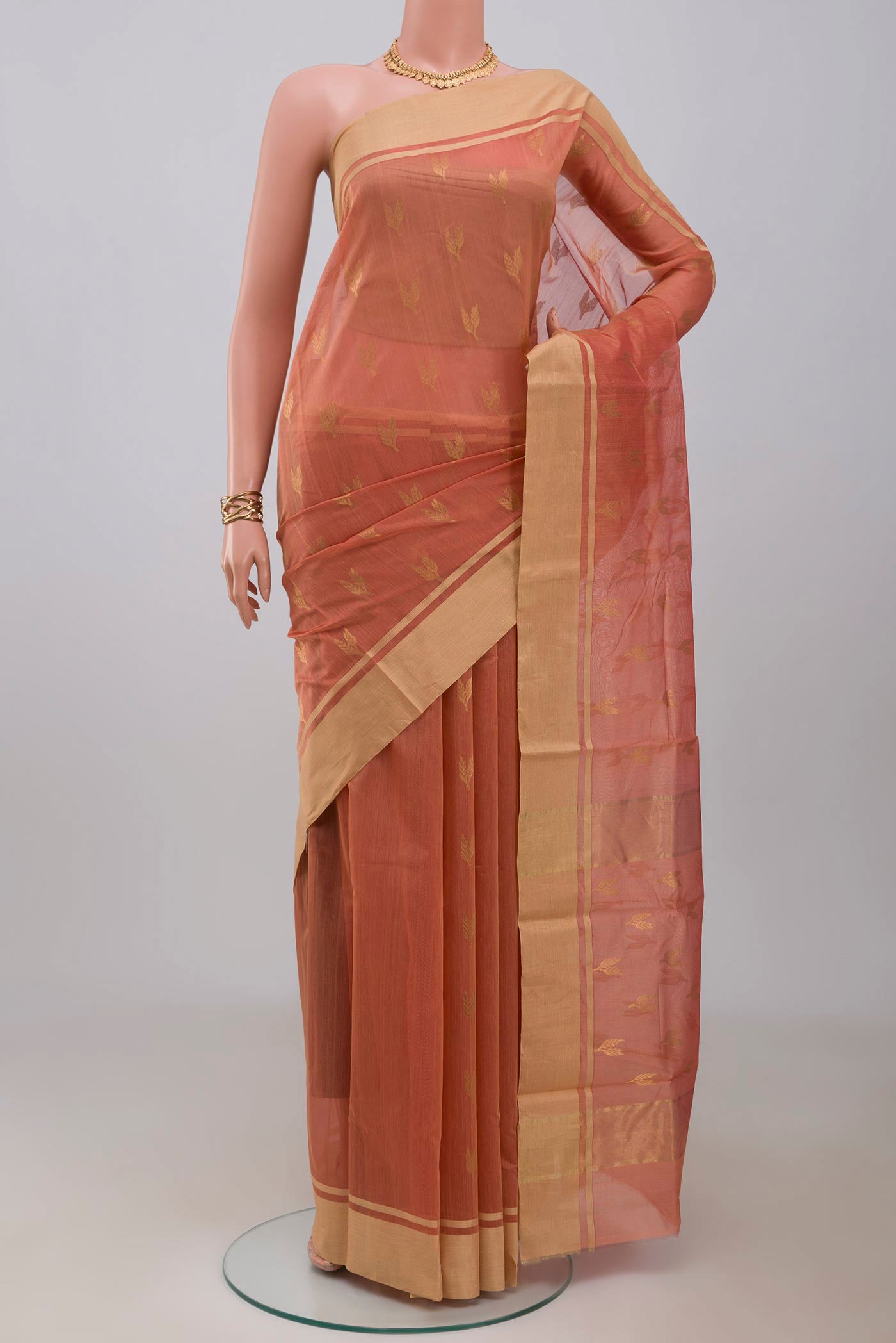 Peach Chanderi Silk Cotton Saree with Zari Butta on the body and Zari Border.  displayed on a mannequin