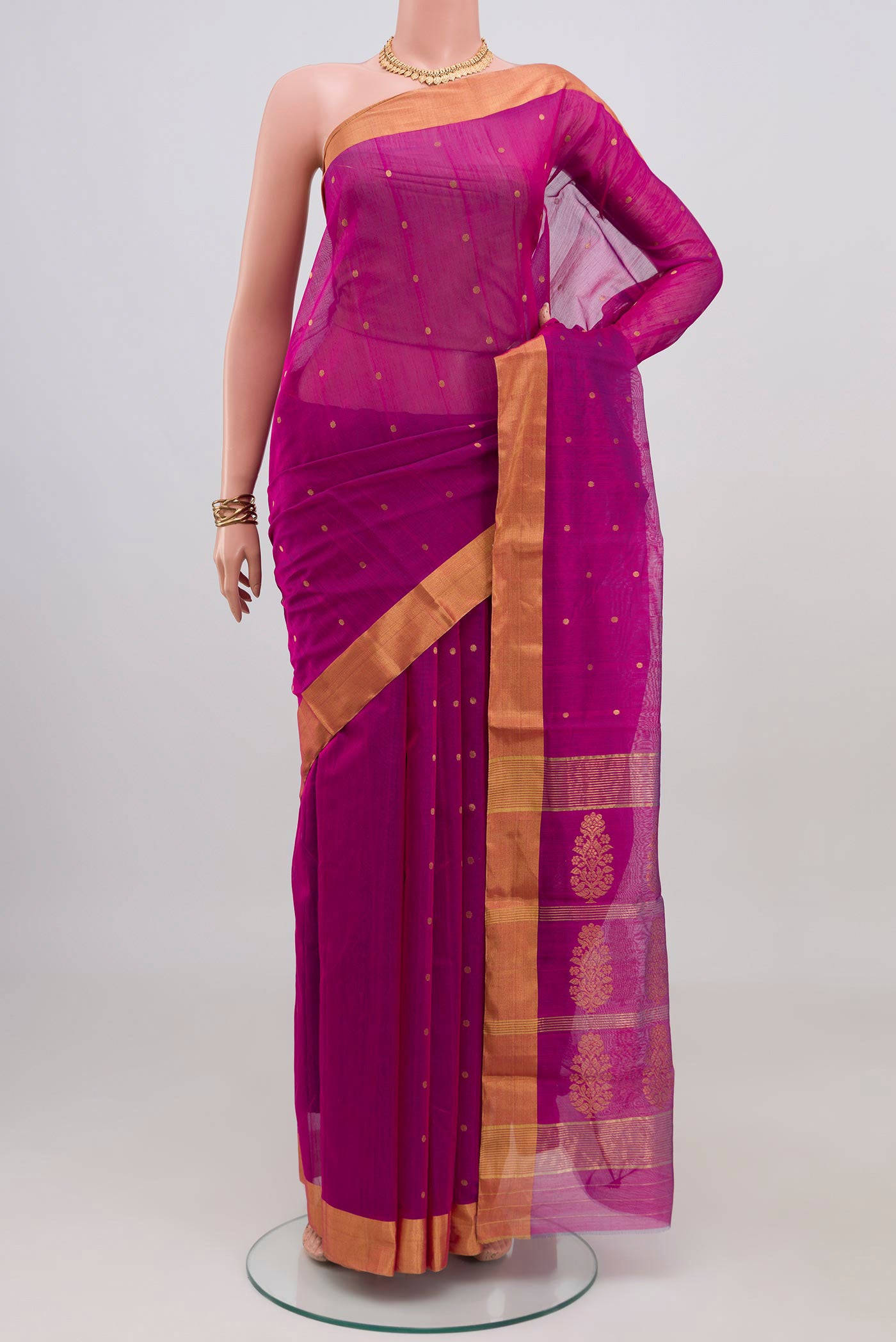 Magenta Chanderi Silk Cotton Saree with Zari Butta on the body and Zari Border.  displayed on a mannequin