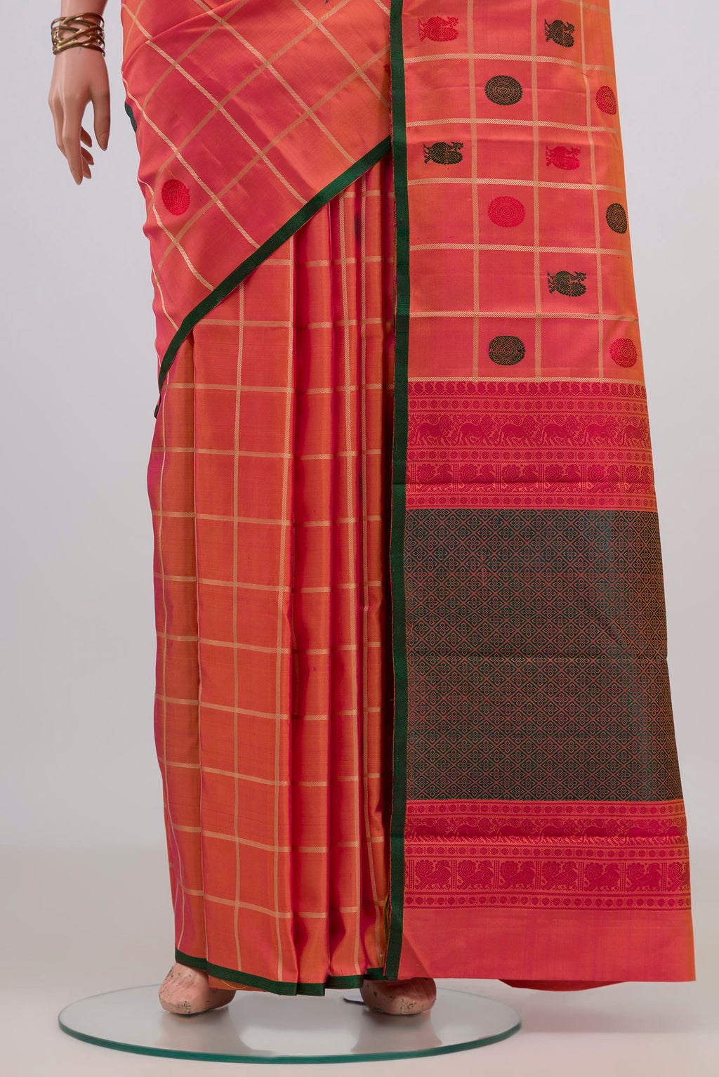 Pleats and pallu of Pure Silk Orange Kanchipuram Saree with Checked design on the body and Without Border. 