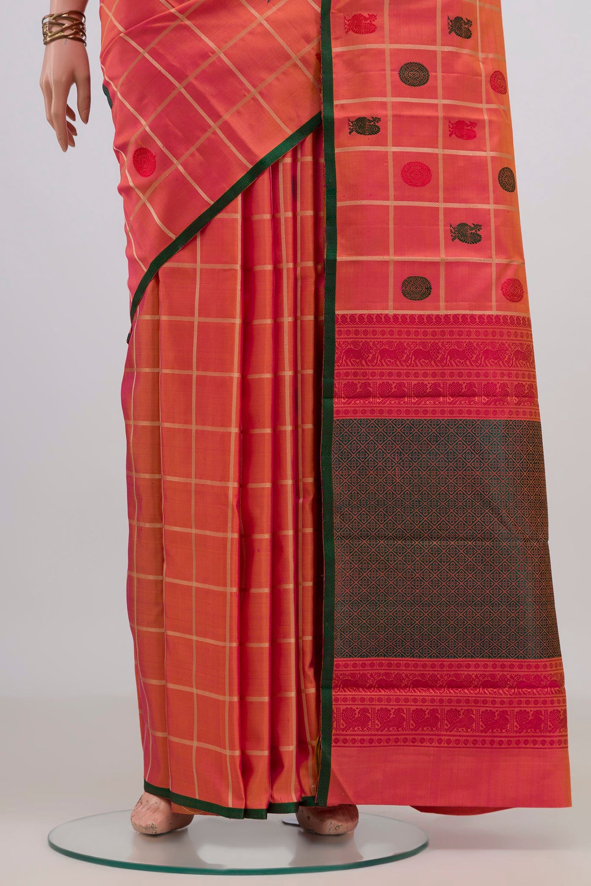 Pleats and pallu of Pure Silk Orange Kanchipuram Saree with Checked design on the body and Without Border. 