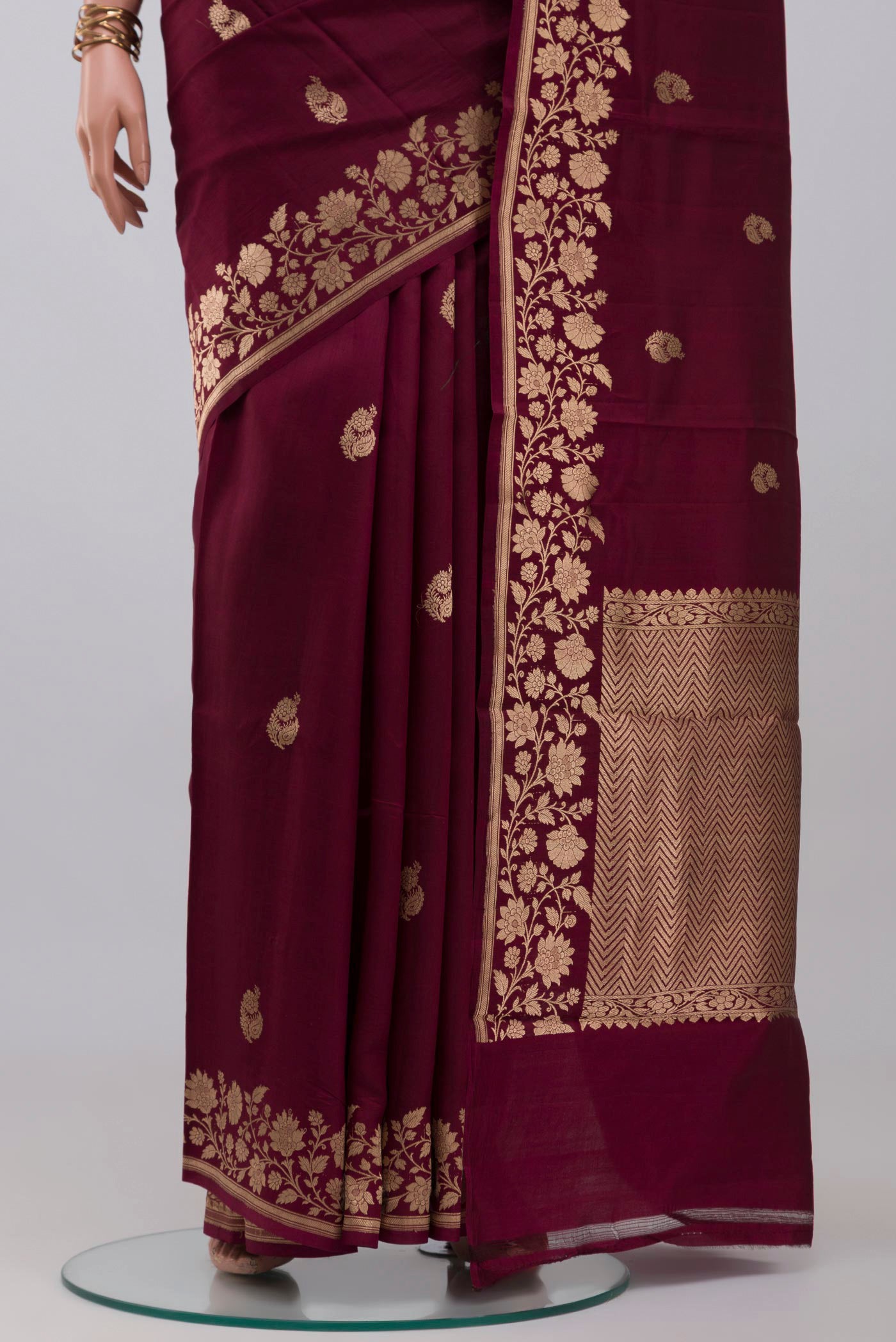 Pleats and pallu of Maroon Banarasi Katan Silk Saree with Zari Butta on the body and Fancy Border. 
