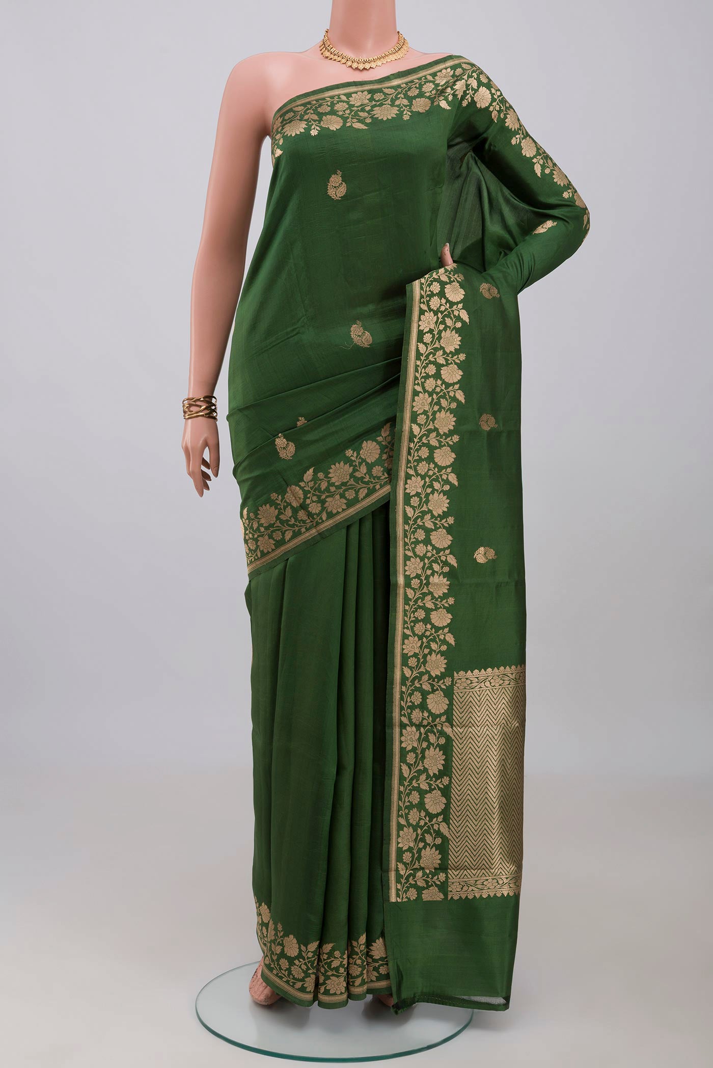Green Banarasi Katan Silk Saree with Zari Butta on the body and Fancy Border.  displayed on a mannequin