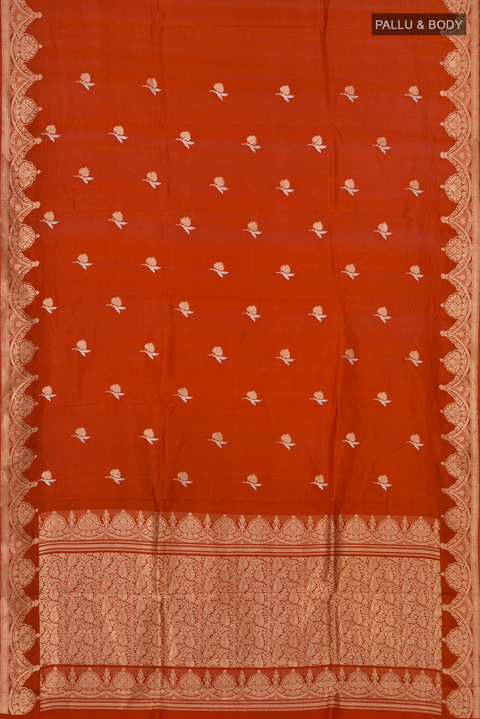 Flat view of Rust Banarasi Katan Silk Saree with Zari Butta on the body and Fancy Border. 