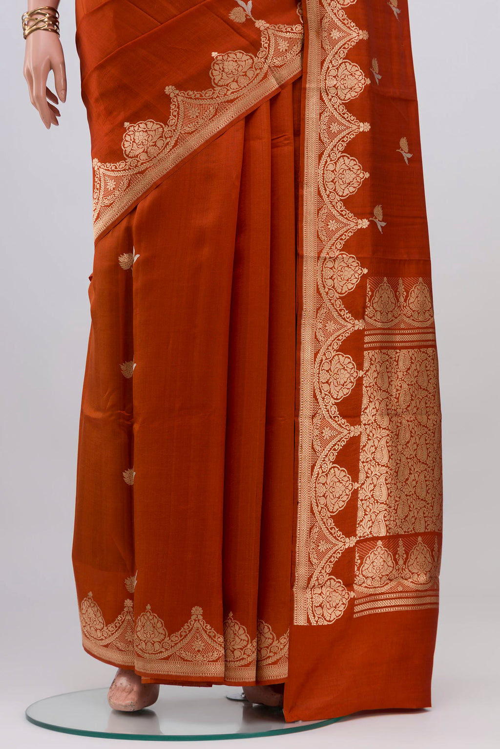 Pleats and pallu of Rust Banarasi Katan Silk Saree with Zari Butta on the body and Fancy Border. 