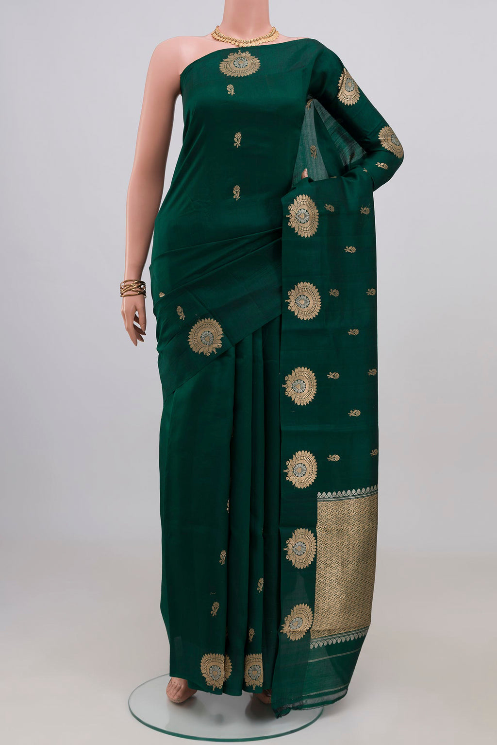 Bottle Green Banarasi Katan Silk Saree with Zari Butta on the body and Fancy Border.  displayed on a mannequin