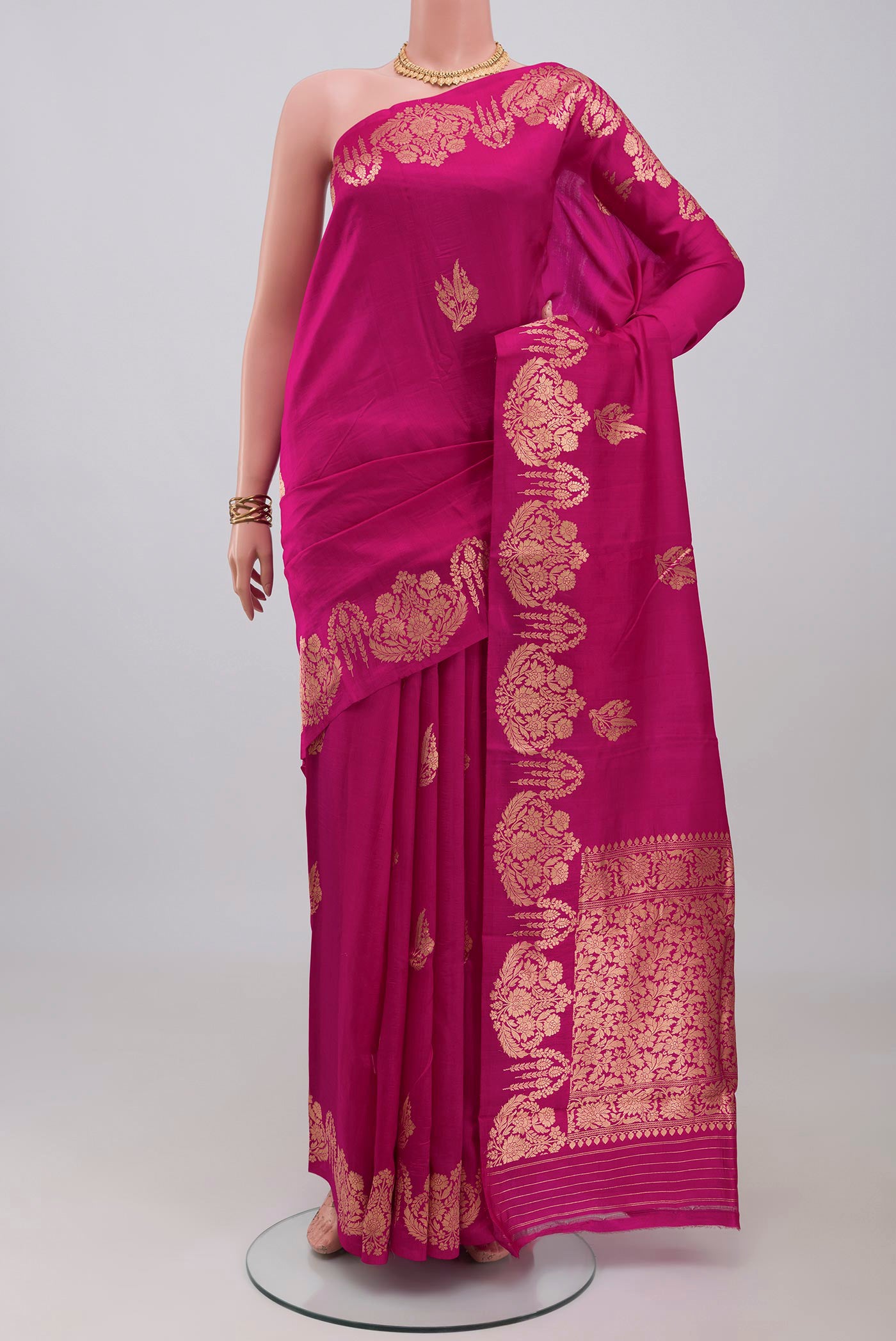 Rani Pink Banarasi Katan Silk Saree with Zari Butta on the body and Fancy Border.  displayed on a mannequin