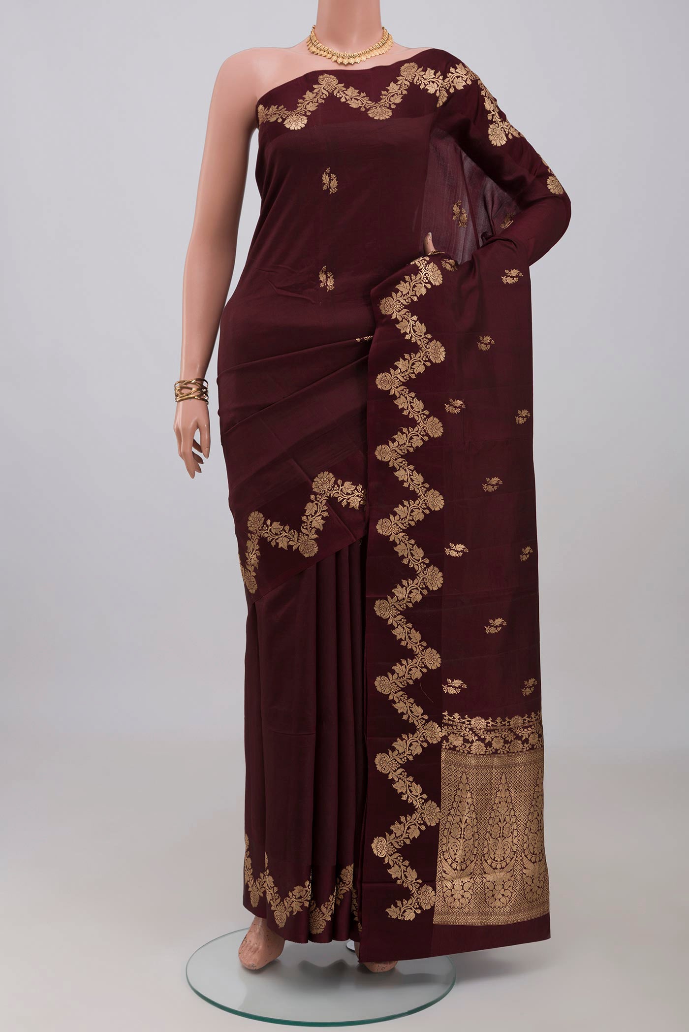 Coffee Brown Banarasi Katan Silk Saree with Zari Butta on the body and Fancy Border.  displayed on a mannequin