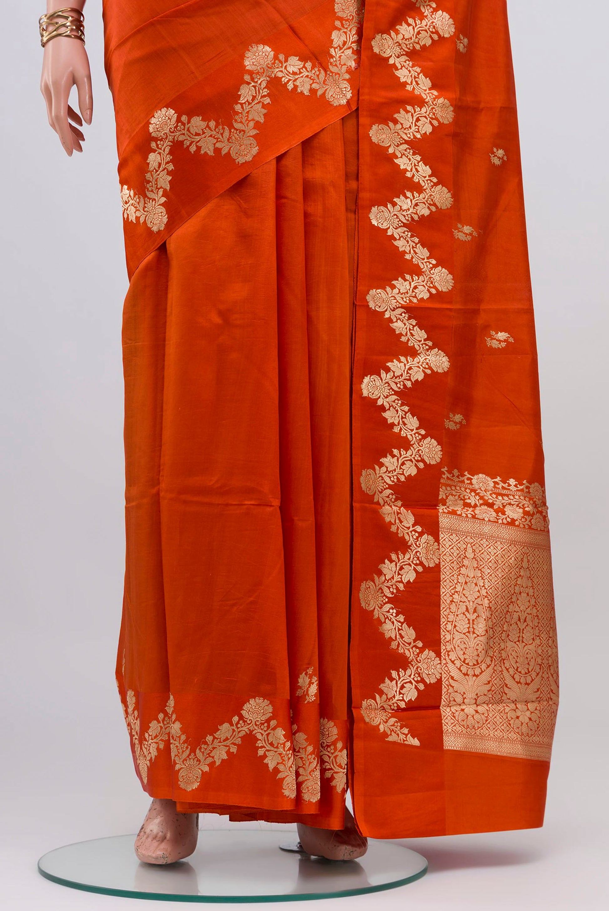 Pleats and pallu of Orange Banarasi Katan Silk Saree with Zari Butta on the body and Fancy Border. 