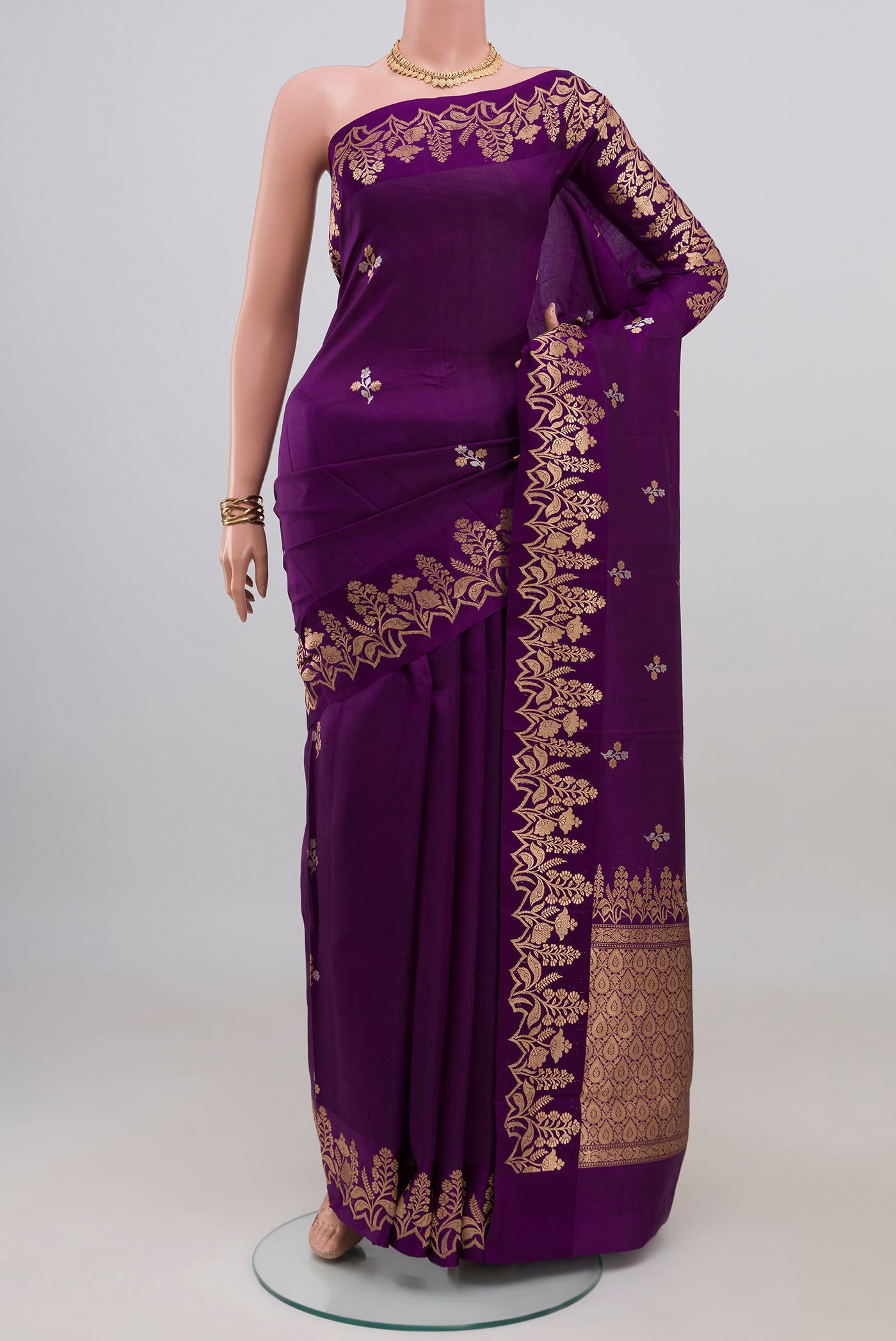Violet Banarasi Katan Silk Saree with Zari Butta on the body and Fancy Border.  displayed on a mannequin