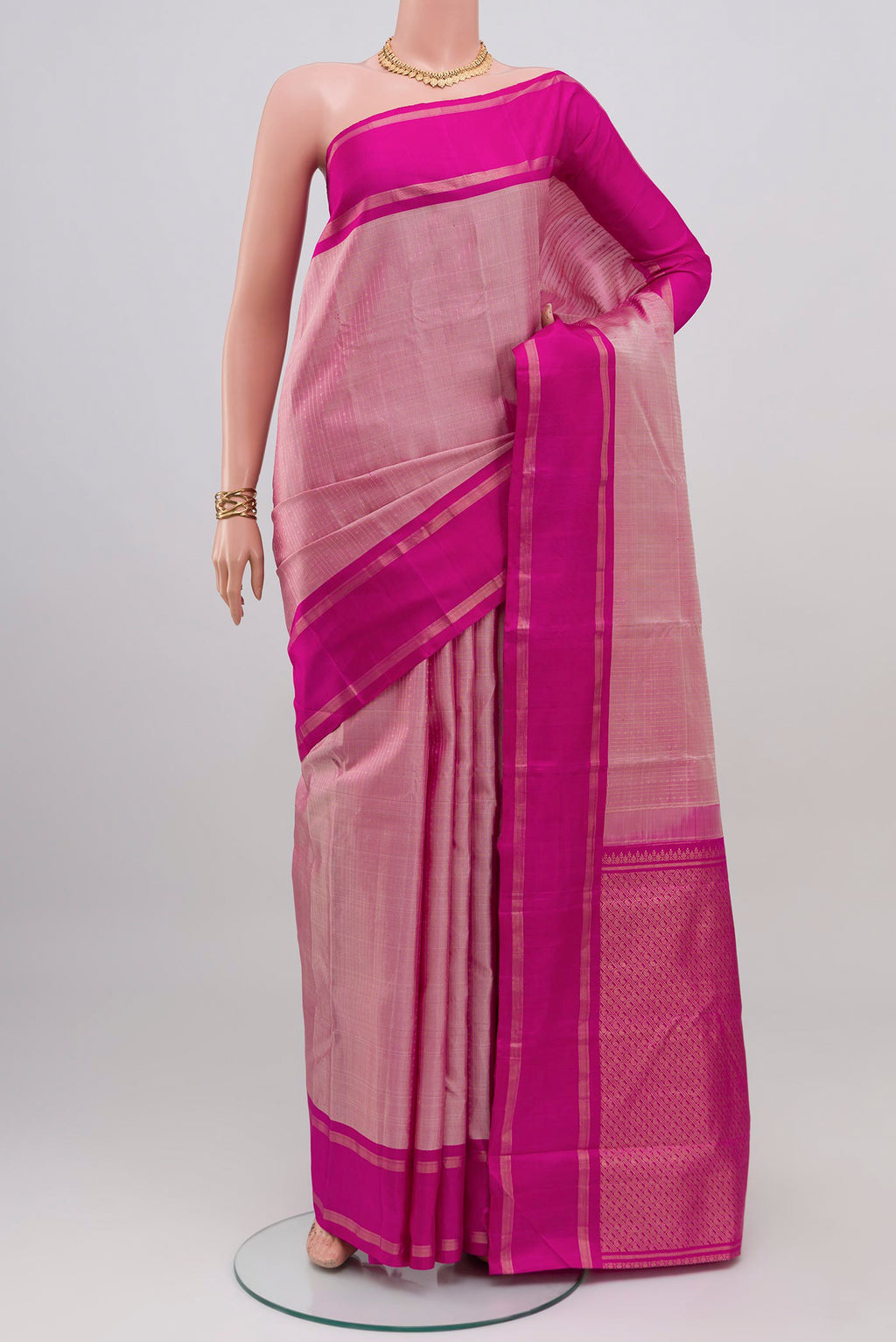 Rose pink Kanchipuram Silk Saree with Stripes on the body and Plain Border.  displayed on a mannequin