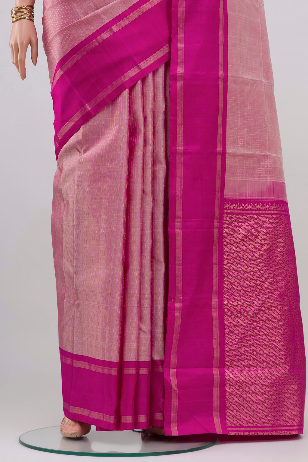 Pleats and pallu of Rose pink Kanchipuram Silk Saree with Stripes on the body and Plain Border. 
