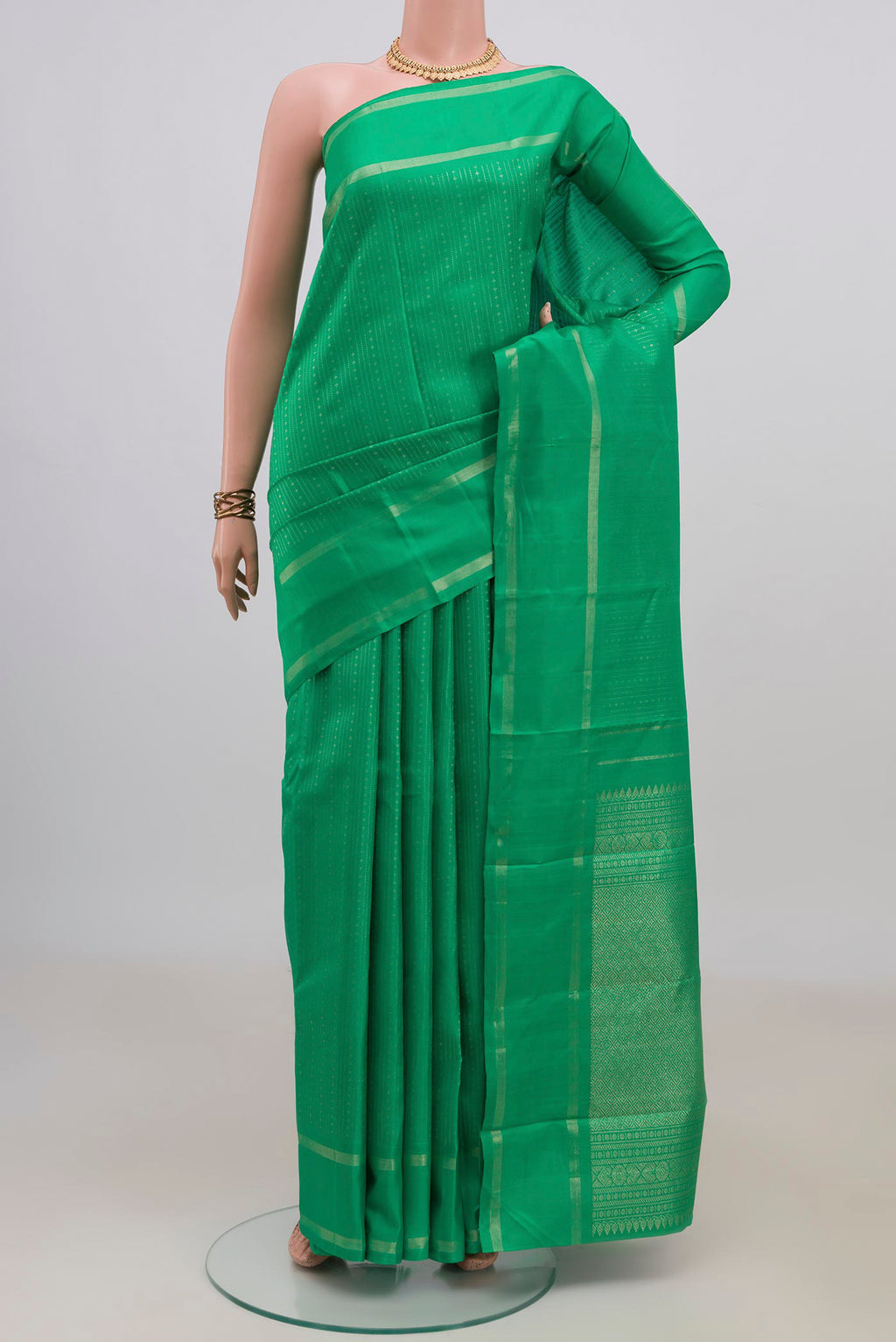 Pure Silk Green Kanchipuram Saree with Stripes on the body and Thin Zari Line.  displayed on a mannequin