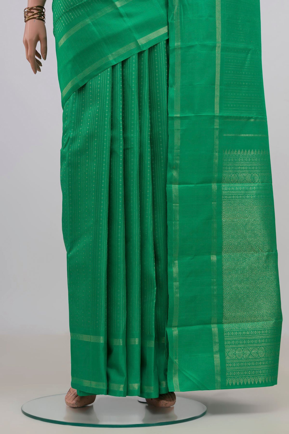 Pleats and pallu of Pure Silk Green Kanchipuram Saree with Stripes on the body and Thin Zari Line. 