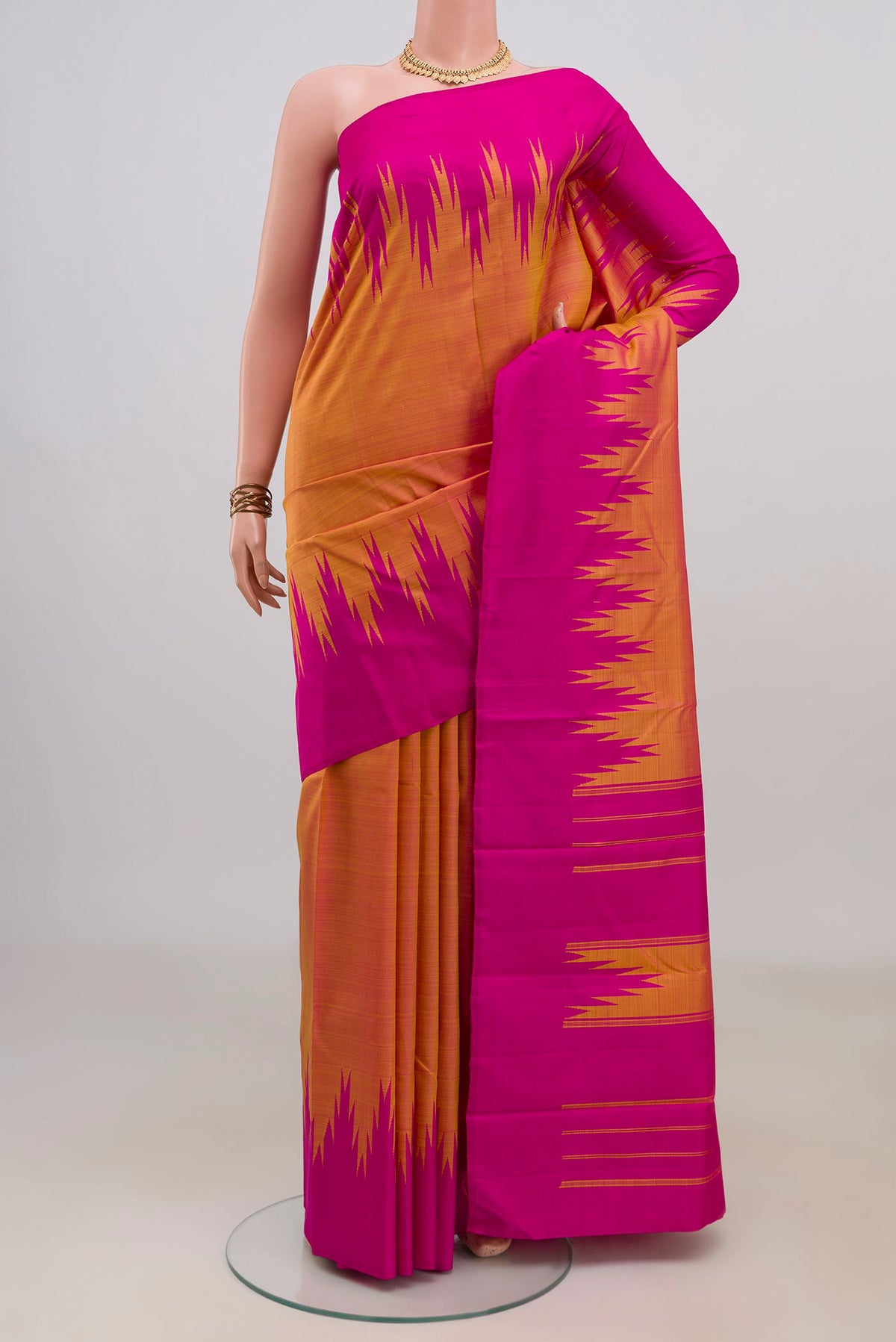 Pure Silk Yellow Kanjivaram Saree with Plain Body and Temple Border.  displayed on a mannequin