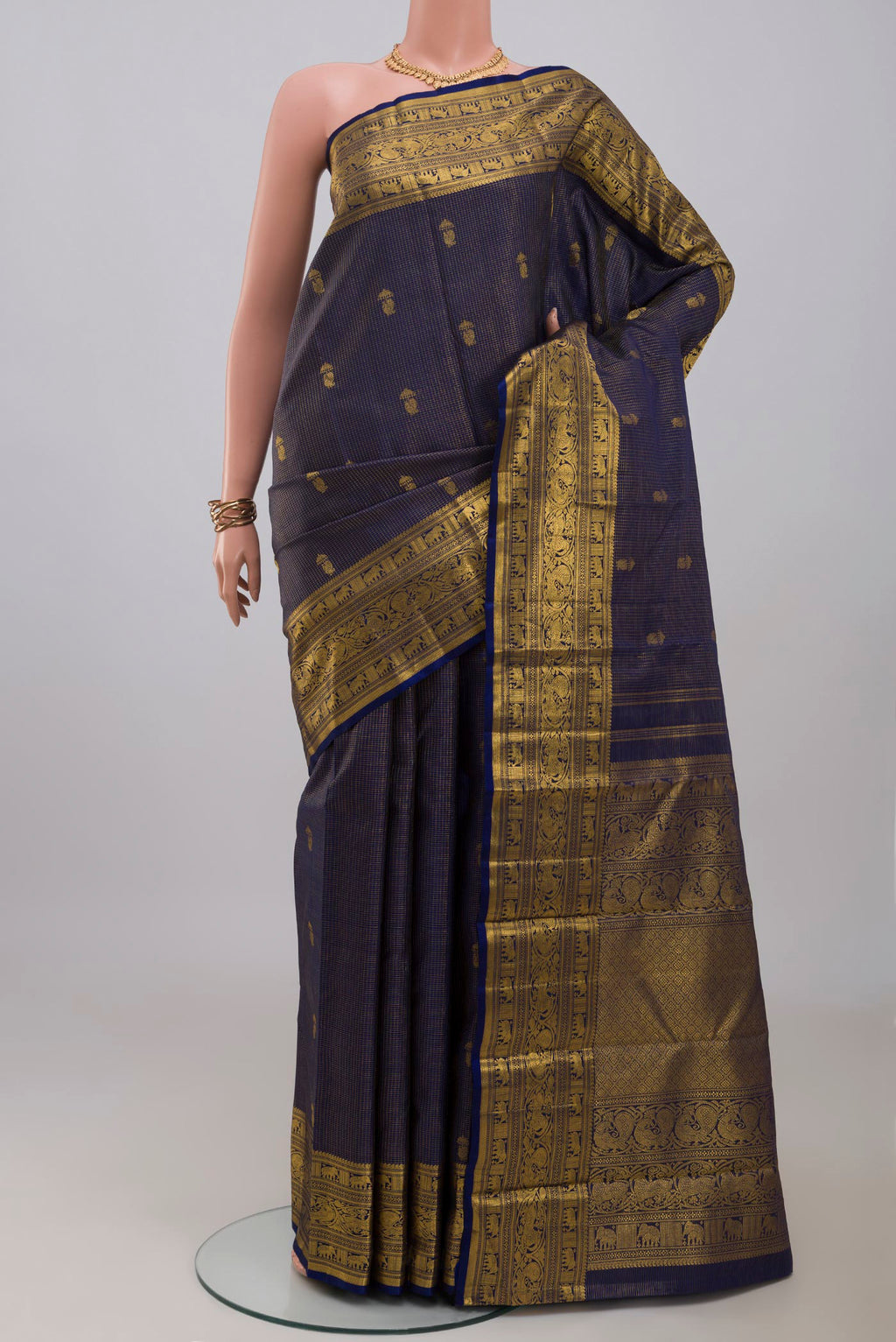 Navy Blue Kanchipuram Silk Saree with Zari Butta on the body and Zari Border.  displayed on a mannequin